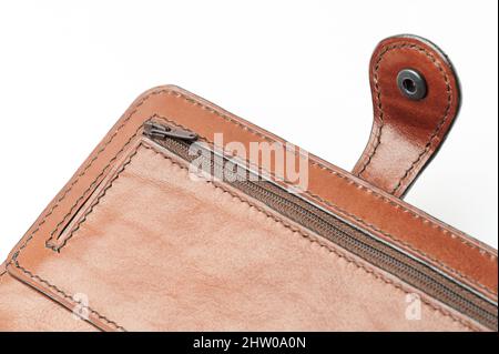 Closed zipper on brown leather wallet isolated Stock Photo