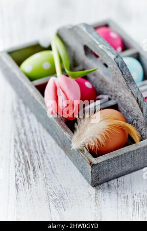 Simple Easter Decoration. Bright wooden background. Close up. Stock Photo