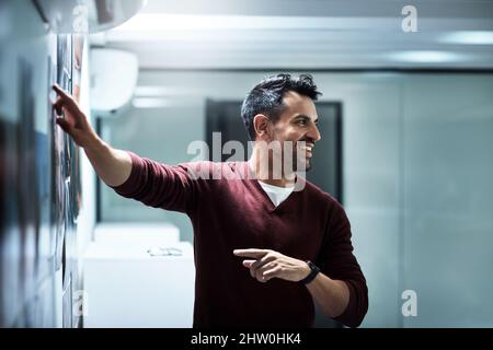 This is how were going to do it. Shot of a businessman presenting his ideas during a brainstorming session at work. Stock Photo