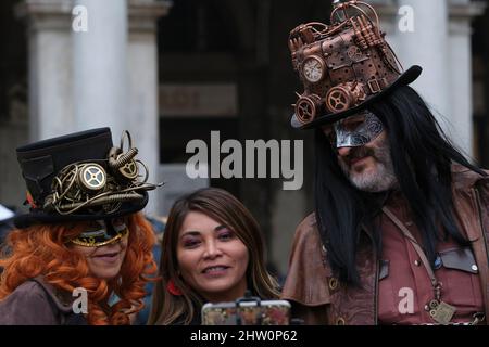 tourists takes a selfie with couple Carnival costumes during Carnival in venice Stock Photo