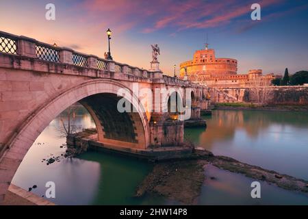 Rome, Italy. Image of the Castle of the Holy Angel and Holy Angel Bridge over the Tiber River in Rome at sunset.