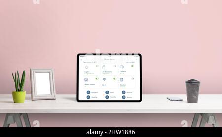 Tablet with smart home app on home desk. Concept home automatization app with important home devices control Stock Photo