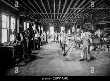 An early 20th century photograph of an aircraft erecting room in Ithaca, New York, United States. In 1914, the Ithaca Board of Trade recognized the potential in aviation development and invited g aircraft designers, William T. and Oliver W. Thomas or “the Thomas brothers” to Ithaca to set up an aircraft manufacturing plant.