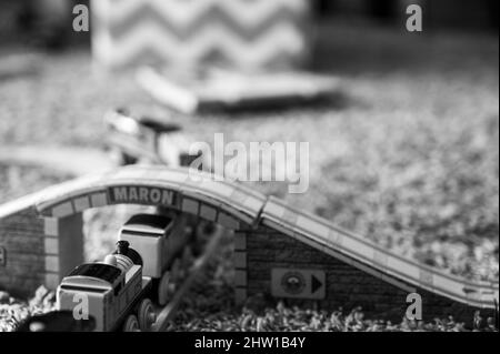 Tiffin, Iowa, USA - 3.2021: Small boy playing with a model Thomas the Train. Thomas is a popular railroad themed children's' toy.  Stock Photo