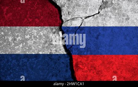 Political relationship between Netherlands and russia. National flags on cracked concrete background Stock Photo