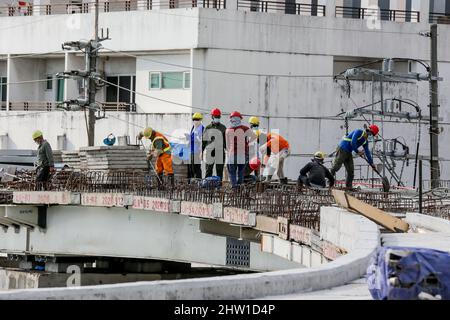 Manila. 3rd Mar, 2022. Workers are seen on the construction site of the China-funded Binondo-Intramuros Bridge in Manila, the Philippines on March 3, 2022. The Binondo-Intramuros Bridge is a steel bowstring arch bridge in Manila City that will connect the Intramuros side and Binondo side over the Pasig River. Credit: Rouelle Umali/Xinhua/Alamy Live News Stock Photo