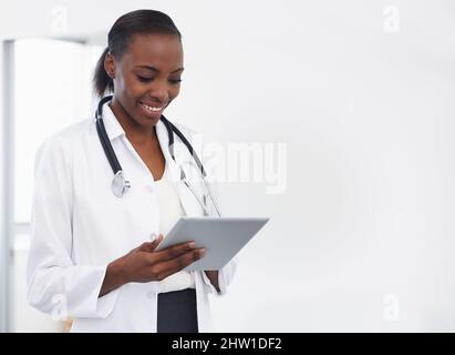 Using technology to make a diagnosis. Shot of a female doctor holding a digital tablet. Stock Photo