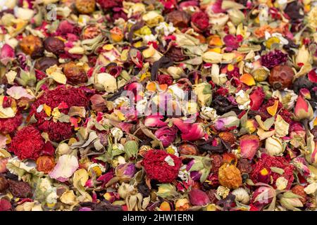 Love herbal tea. Close-up herbal tea. Herbal tea prepared with Bud Rose, Hibiscus, Pomegranate Flower, Chamomile, Dried Rosehip particles. Stock Photo