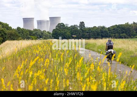 France, Loiret (45), Loire Valley listed as World Heritage by UNESCO, Sully-sur-Loire, cyclist on the Loire by bike route, in the background the Dampiere-en-Burly nuclear power plant Stock Photo