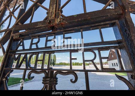 Germany, Bavaria, Dachau, Concentration Camp, entrance gate (Jourhaus), bearing the inscription Arbeit macht frei (Work makes one free), seen from outside the camp Stock Photo