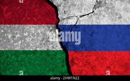 Political relationship between Hungary and russia. National flags on cracked concrete background Stock Photo