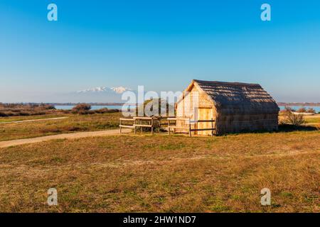 Reed-thatched Hut near a lagoon in Canet-en-Roussillon, Southwestern France. The huts were in use as temporary dwellings by local fishermen. Stock Photo