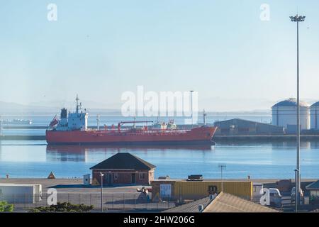Cape Town, South Africa, 26th February - 2022: Ship approaches harbour with fuel tanks in background. Stock Photo