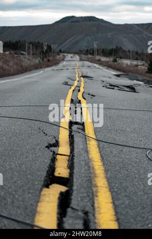 Vertical shot of a broken road, abandoned open-air mine in Black Lake, Quebec, Canada Stock Photo