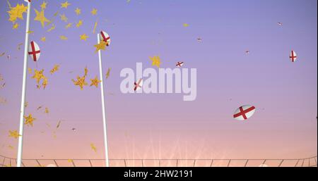 Image of stars over rugby balls coloured with england flag falling at stadium Stock Photo