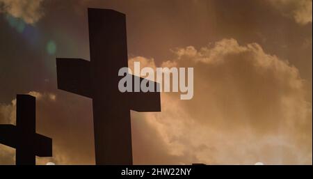 Image of lights over black crucifix shape on clouds Stock Photo
