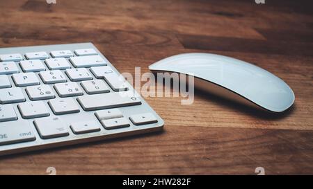Detail of computer keyboard and mouse on wooden table Stock Photo