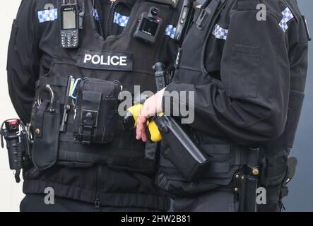 Uk Police officer wearing a tactical vest including a tazer gun, and body camera. Stock Photo