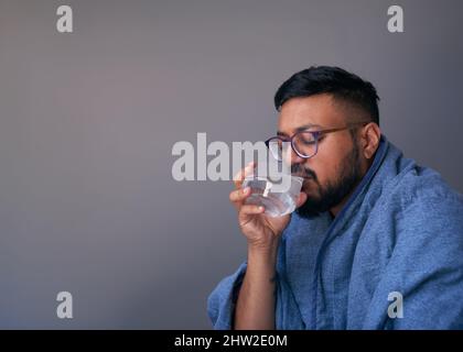 A close up of hands holding an effervescent tablet treating the flu Stock Photo