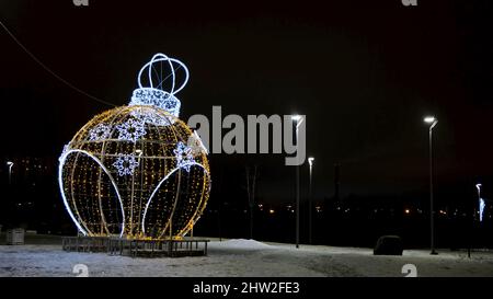 Christmas decoration of garlands on background of night city. Concept. Gazebo in form of Christmas ball made of garlands. Christmas decorations from g Stock Photo