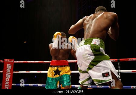 Joseph Lamptey fighting Larry Ekundayo (White Shorts) for the African Boxing Union (ABU) welterweight title during the 'Judgement Day' show at The Troxy, Limehouse, London. October 30, 2015. James Boardman / Telephoto Images +44 7967 642437 Stock Photo