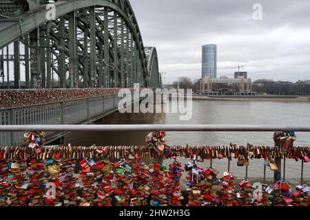 The famous Hohenzollern Bridge is covered with love locks. They are part of the cityscape of Cologne and visited as a popular attraction Stock Photo