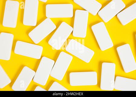 White domino blocks on a yellow background Stock Photo