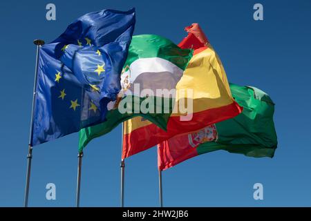 The flags of the EU, Spain, Andalusia and the city of Granada fly from the roof of the Alhambra in Granada, Spain. Stock Photo