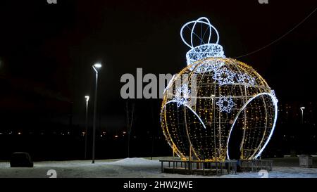 Christmas decoration of garlands on background of night city. Concept. Gazebo in form of Christmas ball made of garlands. Christmas decorations from g Stock Photo