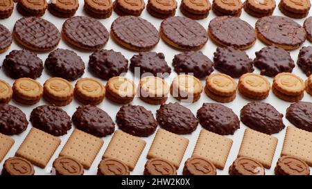 Chocolate coated biscuits, round biscuits, crackers stacked in rows in a horizontal direction Stock Photo