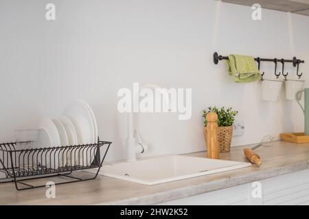 Modern kitchen with shelves, food, spice and dishes.kitchen corner with various cooking utensils including plants,wooden utensils ,glass container Stock Photo