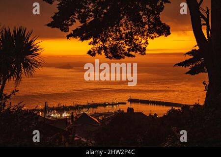 A beautiful, colourful sunrise at the fishing harbour of Newlyn in Mount's Bay, Cornwall, UK Stock Photo