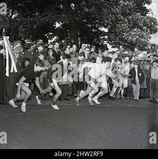 group runners athletes in starting blocks at athletics competition ...