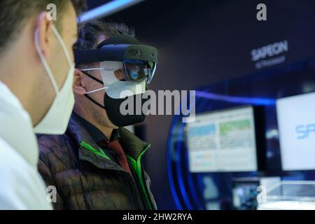 Barcelona, Spain - March 2nd 2022 - Mobile World Congress - a man tries augmented reality glasses Stock Photo