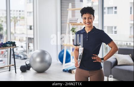 Im a specialist at getting you back to full health. Portrait of a young and confident physiotherapist posing inside her office at a clinic. Stock Photo