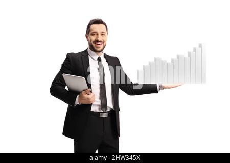 Businessman holding a tablet and presenting a bar chart isolated on white background Stock Photo