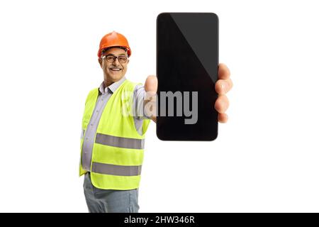 Cheerful male engineer in a reflective vest showing a smartphone isolated on white background Stock Photo