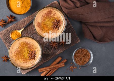 Dessert with turmeric, coffee and cinnamon on a dark background. Top view. Stock Photo