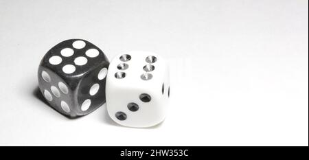 two white and black dices on a white background Win or lose Catch your luck Gambling equipment Stock Photo