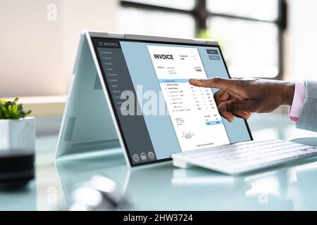 E Invoice Business Management. Accountant Using Electronic Invoice Stock Photo