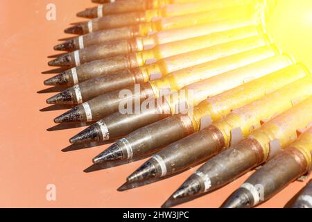 Weapon cartridges ammunitions on stone dark base. Military conflict concept Stock Photo
