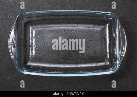 A baking dish cleaned from a thick layer of carbon. Glassware for baking after washing with a steam cleaner. Stock Photo