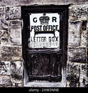 Historic black and white postbox, letter box, built into a stone wall, Canterbury, England Stock Photo