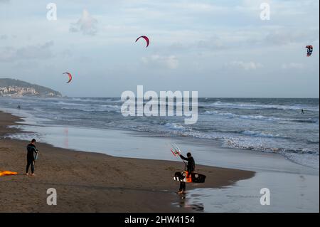 Water sport at cold winter water of Tyrrhenian sea between two touristic towns Sperlonga and Terracina in Lazio, Italy, panoramic  view Stock Photo