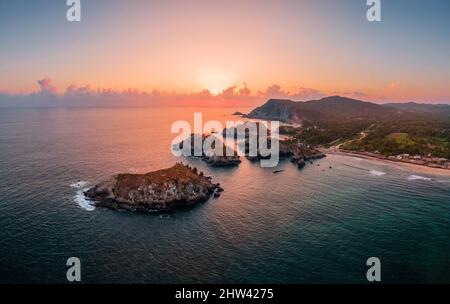 Sunset over the rocky islands at the Maruata beach, Michoacan, Mexico Stock Photo