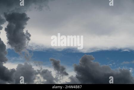 Weather, Clouds, storm brewing? Different types and layers  of clouds, fluffy grey on white on blue sky. Presentation background with text copy space. Stock Photo