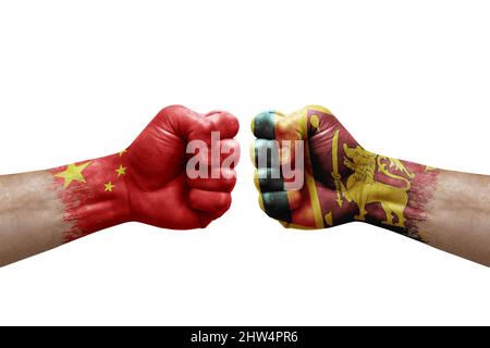 Two hands punch to each others on white background. Country flags painted fists, conflict crisis concept between china and sri lanka Stock Photo