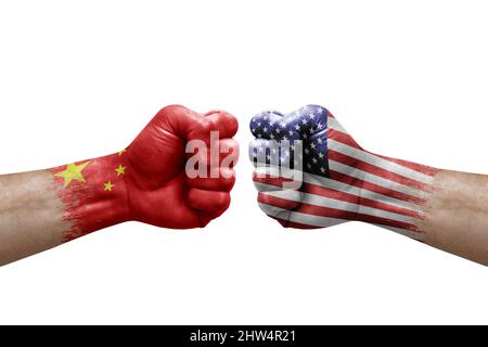 Two hands punch to each others on white background. Country flags painted fists, conflict crisis concept between china and usa