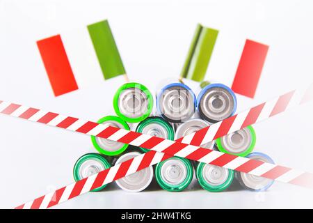 Battery ban in Italy. Batteries are enclosed with red and white tape. Disposal of waste from batteries. Dump of electronic waste. Stock Photo