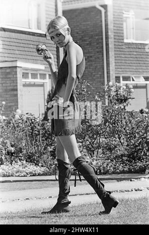 Twiggy, (real name Lesley Hornby) English model, seen in a Hippie gear outfit.  Pictured before she left for the New York, America, USA later the same day. Twiggy said of her Hippie outfit, 'I Love it !   I have a Hippie hat, it's straw with poppies on the side.  But I couldn't wear it today because it doesn't go with this outfit.  That shows I'm not a real Hippie doesn't it ?  If I was, I'd wear it anyway wouldn't I ? ' she goes on to say 'I think the clothes can be adapted to everyday wear, we're certainly planning some for the next Twiggy range'  Picture taken 21st August 1967 Stock Photo